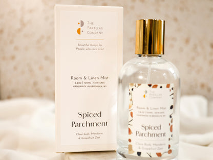 Spiced Parchment scented room and linen mist glass bottle and pretty packaging box on a terrazzo background